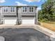 Gray townhouses with attached garages, and landscaping at 2121 Acclaim St, Charlotte, NC 28205