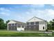 Rear view of townhomes showcasing gray siding, white trim, and garage at 2125 Acclaim St, Charlotte, NC 28205