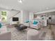 Open living room with modern furniture, wood-look floors, and a kitchen at 2137 Acclaim St, Charlotte, NC 28205