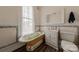 Bathroom with clawfoot tub, mosaic tile, and white vanity at 404 W Kerr St, Salisbury, NC 28144