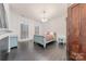 Bedroom with teal sleigh bed, dark hardwood floors, and fireplace at 404 W Kerr St, Salisbury, NC 28144