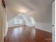 Large attic bedroom with hardwood floors and window at 404 W Kerr St, Salisbury, NC 28144