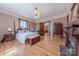 Spacious bedroom with hardwood floors, fireplace, and antique furniture at 404 W Kerr St, Salisbury, NC 28144