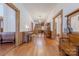 Long entryway with hardwood floors, antique furniture, and staircase at 404 W Kerr St, Salisbury, NC 28144