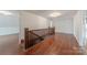 Long hallway with hardwood floors and wooden railing at 404 W Kerr St, Salisbury, NC 28144