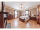 Main bedroom with hardwood floors, large bed, and antique furniture at 404 W Kerr St, Salisbury, NC 28144