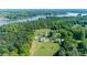 Expansive aerial view of a property featuring multiple buildings, lush greenery, and a lake at 796 Cornelius Rd, Mooresville, NC 28117
