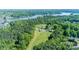 Beautiful aerial view of wooded acreage with a lake in the background at 796 Cornelius Rd, Mooresville, NC 28117
