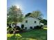 Back exterior of the home surrounded by a neatly maintained lawn, mature trees, and an HVAC unit at 796 Cornelius Rd, Mooresville, NC 28117