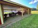 Carport showing a tractor and trailer with gravel and grass at 796 Cornelius Rd, Mooresville, NC 28117