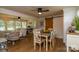 Sunlit dining room with hardwood floors connecting to the living room, featuring a wooden table with seating for six at 796 Cornelius Rd, Mooresville, NC 28117