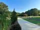 Long, paved driveway bordered by lush greenery and a wooden fence, leading to a home at 796 Cornelius Rd, Mooresville, NC 28117