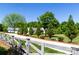 Long, paved driveway framed by a white wooden fence and lush green landscaping at 796 Cornelius Rd, Mooresville, NC 28117
