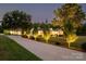 Well-lit single story home featuring an extended driveway, pristine lawn, and mature trees at 796 Cornelius Rd, Mooresville, NC 28117