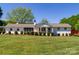Charming single-story home with a well-manicured lawn and mature landscaping at 796 Cornelius Rd, Mooresville, NC 28117