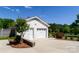 Detached two-car garage with white painted brick and manicured landscaping at 796 Cornelius Rd, Mooresville, NC 28117