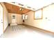 Spacious garage with painted floor, natural wood ceiling, windows, and a white door leading outside at 796 Cornelius Rd, Mooresville, NC 28117