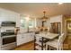 Bright kitchen with white cabinets, stainless steel appliances, hardwood floors, and a center island with seating at 796 Cornelius Rd, Mooresville, NC 28117