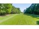 Sprawling land with lush green grass lined with trees for sale at 796 Cornelius Rd, Mooresville, NC 28117