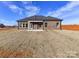 Expansive backyard view of a brick home with a covered patio, perfect for outdoor living at 1108 Piper Meadows Dr # 52, Waxhaw, NC 28173