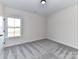 Well-lit bedroom with neutral carpeting and a window overlooking a field at 1108 Piper Meadows Dr # 52, Waxhaw, NC 28173