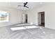 Spacious bedroom with plush carpet, ceiling fan, and doorways leading to other rooms at 1108 Piper Meadows Dr # 52, Waxhaw, NC 28173