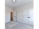 Bedroom with neutral carpeting and trim, featuring an open door and closet at 1108 Piper Meadows Dr # 52, Waxhaw, NC 28173