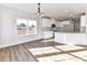 Bright open dining room with views to the kitchen, hardwood floors, and large window at 1108 Piper Meadows Dr # 52, Waxhaw, NC 28173