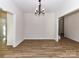 Dining room with wood floors, stylish chandelier, and doorways to adjacent rooms at 1108 Piper Meadows Dr # 52, Waxhaw, NC 28173