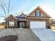 Charming brick home featuring a two-car garage, well-manicured lawn, and inviting front entrance at 1108 Piper Meadows Dr # 52, Waxhaw, NC 28173