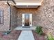 Classic brick home entrance with covered porch and manicured landscape at 1108 Piper Meadows Dr # 52, Waxhaw, NC 28173