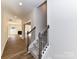Hallway with hardwood floors, a staircase with carpet and a glimpse into the living room at 1108 Piper Meadows Dr # 52, Waxhaw, NC 28173