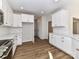 Modern kitchen with sleek white cabinets, countertops, and stainless steel appliances at 1108 Piper Meadows Dr # 52, Waxhaw, NC 28173