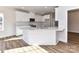 Modern kitchen with white cabinets, white countertops, an island, and stainless steel appliances at 1108 Piper Meadows Dr # 52, Waxhaw, NC 28173