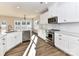 Well-lit kitchen with stainless steel appliances, white cabinets, and hardwood floors at 1108 Piper Meadows Dr # 52, Waxhaw, NC 28173