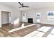 Spacious living room with hardwood floors, ceiling fan, fireplace, and natural light at 1108 Piper Meadows Dr # 52, Waxhaw, NC 28173