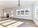 Open-concept living area featuring hardwood floors, fireplace, and large windows at 1108 Piper Meadows Dr # 52, Waxhaw, NC 28173