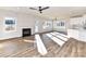 Sunlit living room with fireplace, fan, and seamless flow to the modern kitchen at 1108 Piper Meadows Dr # 52, Waxhaw, NC 28173