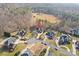 Aerial view of a beautiful home nestled in a cul-de-sac surrounded by lush greenery and mature trees at 2012 Tomshire Dr, Gastonia, NC 28056