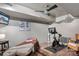 Basement workout room with a TV, ceiling fan, massage table and exercise bike at 2012 Tomshire Dr, Gastonia, NC 28056