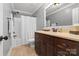 Bathroom with tile flooring, dark wood cabinets, and shower-tub combo at 2012 Tomshire Dr, Gastonia, NC 28056