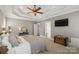 Comfortable bedroom with tray ceiling, closet access, and flatscreen television at 2012 Tomshire Dr, Gastonia, NC 28056