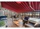 Covered deck with an outdoor kitchen, bar, seating and a wooded view at 2012 Tomshire Dr, Gastonia, NC 28056