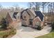Stunning brick home with a large driveway and attached garage on a sunny day at 2012 Tomshire Dr, Gastonia, NC 28056