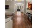 Elegant hallway with hardwood floors, an arched entrance, and a staircase leading to the upper level at 2012 Tomshire Dr, Gastonia, NC 28056