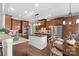 Well-equipped kitchen boasting stainless steel appliances, wooden cabinets, and a dining table at 2012 Tomshire Dr, Gastonia, NC 28056