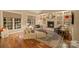 Inviting living room with large windows, fireplace, built-in shelving, and hardwood floors at 2012 Tomshire Dr, Gastonia, NC 28056