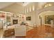 Elegant living room featuring high ceilings, fireplace, built-in shelves, and hardwood floors at 2012 Tomshire Dr, Gastonia, NC 28056