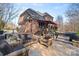 Backyard patio featuring wicker furniture, a hot tub and a view of the brick home at 2012 Tomshire Dr, Gastonia, NC 28056
