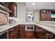 Modern wet bar with granite countertops, stainless steel appliances, and custom cabinets at 2012 Tomshire Dr, Gastonia, NC 28056